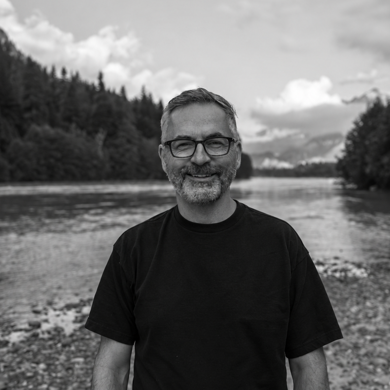 Dave Kurvers by the water with North Shore mountains in the background